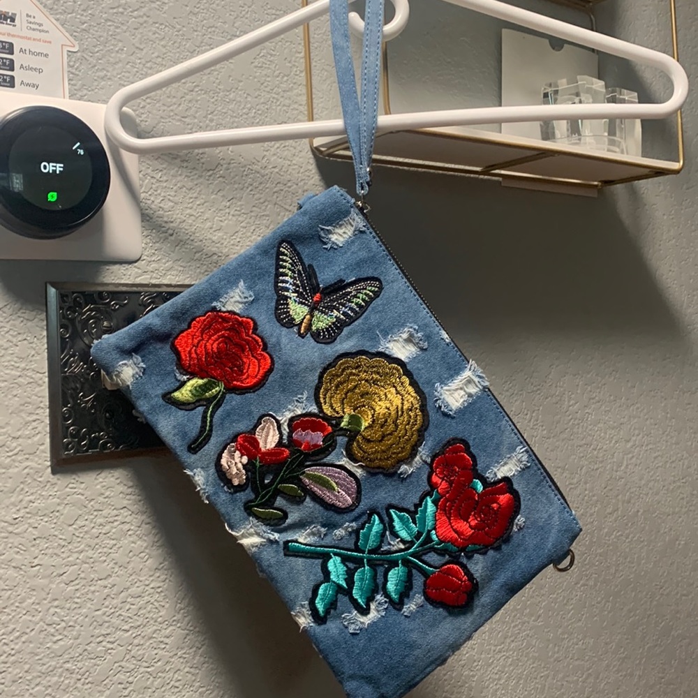 denim's purse with stylish patches and attachable chain strap